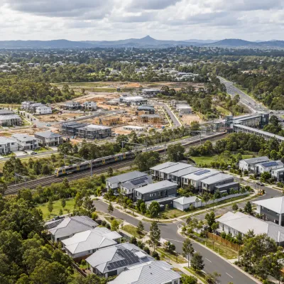 Brisbane northern growth corridor with new housing, rail infrastructure and expanding residential development, representing investment driven by connectivity and population growth.
