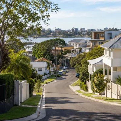 Leafy residential street with riverside homes in Bulimba and Hawthorne, Brisbane, showcasing the local property market and neighbourhood lifestyle.