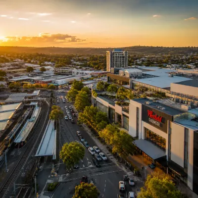 Aerial view of Chermside at sunset featuring Westfield Chermside, transport links and surrounding residential areas for property investment.