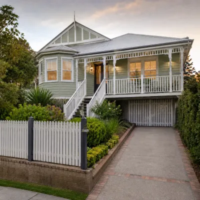 Grey character home in Paddington, Brisbane, featuring a traditional Queenslander-style facade, veranda, landscaped garden, and driveway.