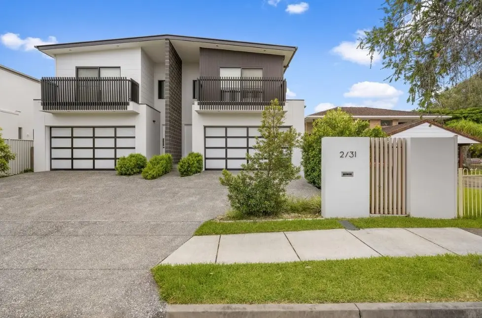 Modern two-storey duplex with balconies and twin garages at 2/31 Parr Street, Biggera Waters