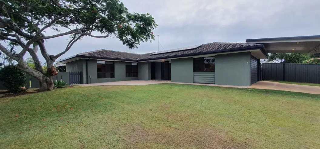 Low-set grey brick home with a carport, set behind a large lawn at 31 Southerly Street, Mermaid Waters