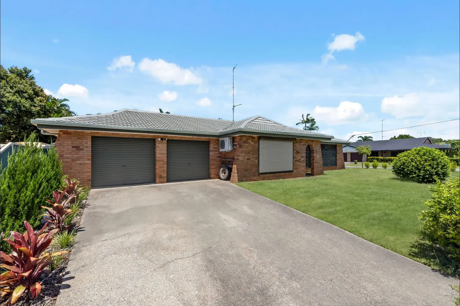 Brick home with a double garage and a curved driveway at 2 Fairway Drive, Mermaid Waters