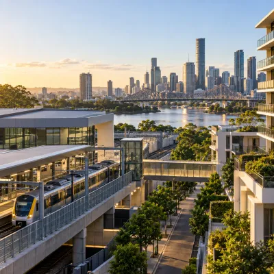 Brisbane rail station and train beside modern residential developments with the river and city skyline beyond, representing property opportunities connected to the Cross River Rail corridor.