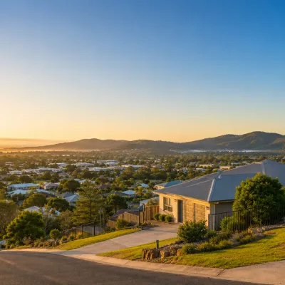 Regional Queensland residential community at sunrise featuring family homes, green landscapes, and growing suburban areas highlighting long-term property investment opportunities.