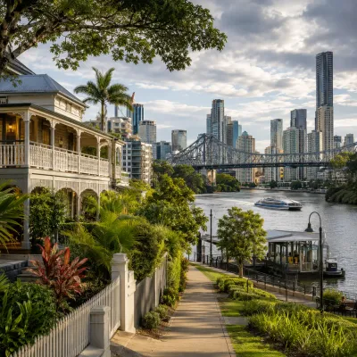Queenslander home, river ferry terminal and Brisbane skyline under a cloudy sky, representing the lifestyle, connectivity and appeal drawing interstate buyers to Queensland in 2026.